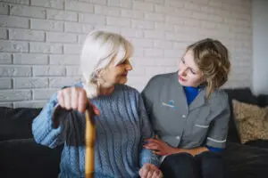 One of Advanced Care's home care assistant sitting with a service user